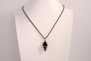 Black onyx spiral crystal pendant necklace on black cord chain displayed on white bust