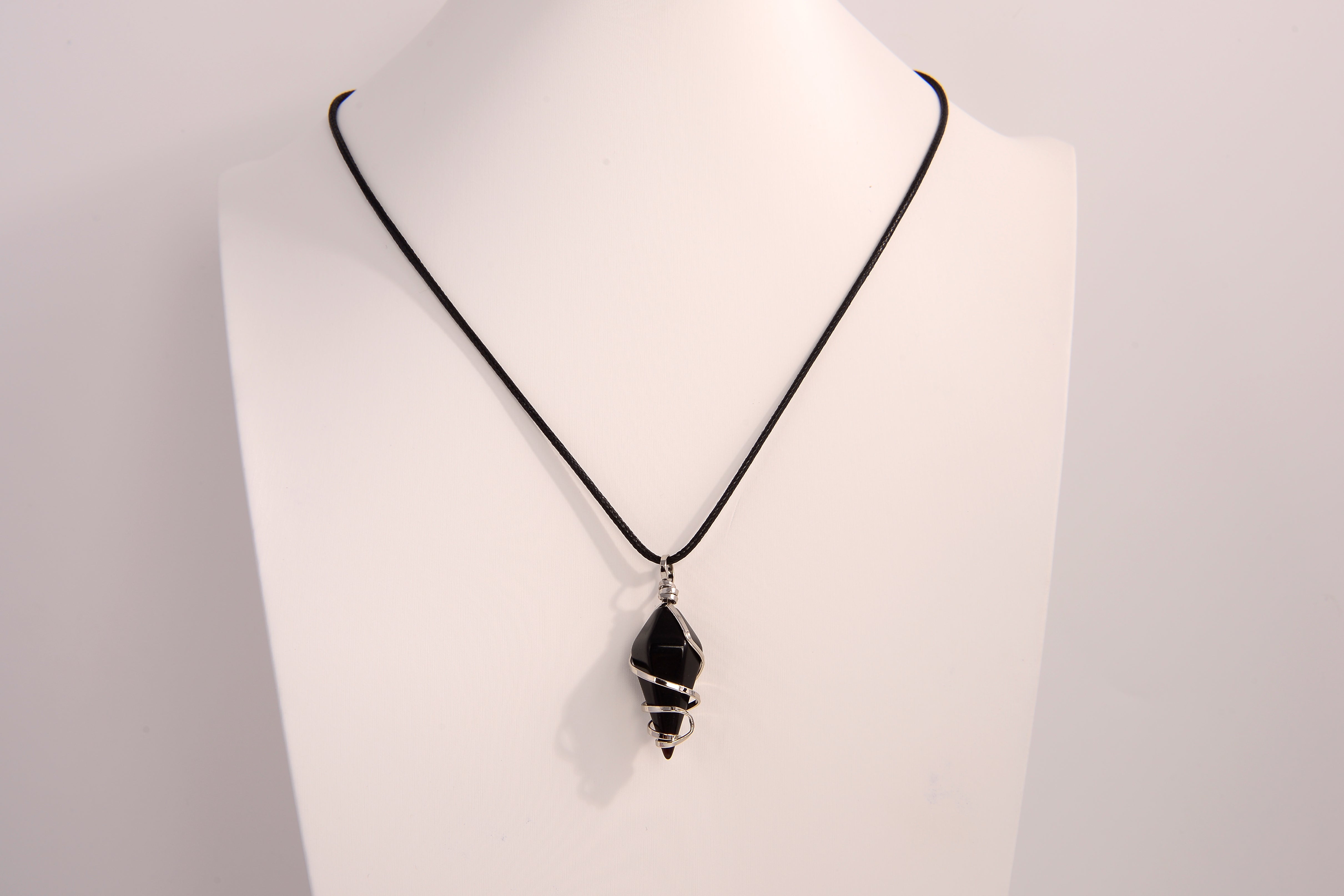 Black onyx spiral crystal pendant necklace on black cord chain displayed on white bust