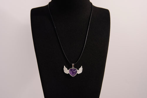 Raw Earth Crystals amethyst heart with wings necklace, featuring a deep purple heart-shaped stone adorned with delicate angelic wings, designed to enhance intuition, promote spiritual growth, and support inner peace.