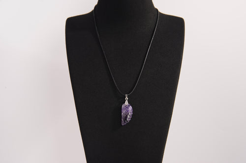 Raw Earth Crystals amethyst pendant featuring an etched design, crafted from natural stone to enhance spiritual awareness, calm the mind, and support emotional balance.