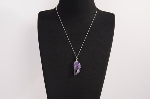 Raw Earth Crystals amethyst pendant featuring an etched design, crafted from natural stone to enhance spiritual awareness, calm the mind, and support emotional balance.