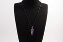 Raw Earth Crystals amethyst pendant with a spiral wire wrap design, crafted from natural stone to support spiritual growth, intuition, and inner peace.