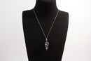 Raw Earth Crystals amethyst pendant with a spiral wire wrap design, crafted from natural stone to support spiritual growth, intuition, and inner peace.