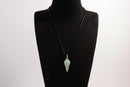 Raw Earth Crystals aventurine pendant with a spiral wire wrap design, crafted from natural stone to enhance luck, prosperity, and emotional balance.