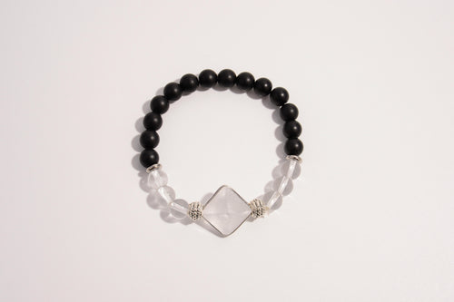 Raw Earth Crystals black onyx and clear quartz bracelet with silver accent, crafted from natural crystals, promotes clarity, protection, and spiritual alignment.