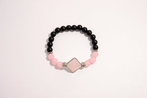 Raw Earth Crystals black onyx and pink quartz bracelet with silver accent, crafted from natural crystals, promotes emotional balance, love, and inner peace.