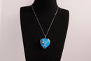 Raw Earth Crystals blue howlite heart pendant with an elegant rose design, featuring a vibrant blue howlite stone and a silver-tone vine with leaves, promoting calmness, emotional stability, and focus.