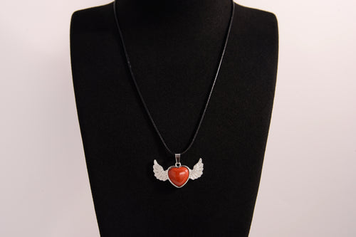 Raw Earth Crystals carnelian heart with wings necklace, featuring a vibrant orange-red heart-shaped stone adorned with delicate angelic wings, designed to boost energy, enhance motivation, and support emotional strength.