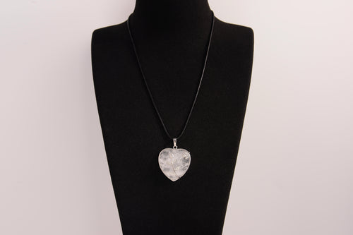 Raw Earth Crystals clear quartz heart pendant with an elegant rose design, featuring a delicate silver-tone stem and leaves embedded in natural clear quartz, promoting clarity, love, and spiritual connection.