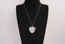 Raw Earth Crystals clear quartz heart pendant with an elegant rose design, featuring a delicate silver-tone stem and leaves embedded in natural clear quartz, promoting clarity, love, and spiritual connection.