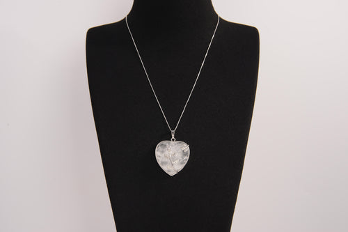 Raw Earth Crystals clear quartz heart pendant with an elegant rose design, featuring a delicate silver-tone stem and leaves embedded in natural clear quartz, promoting clarity, love, and spiritual connection.