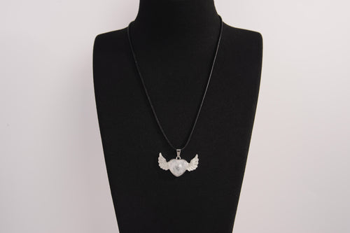 Raw Earth Crystals clear quartz heart with wings necklace, featuring a luminous heart-shaped stone adorned with angelic wings, designed to amplify energy, enhance clarity, and offer spiritual protection.