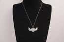 Raw Earth Crystals clear quartz heart with wings necklace, featuring a luminous heart-shaped stone adorned with angelic wings, designed to amplify energy, enhance clarity, and offer spiritual protection.