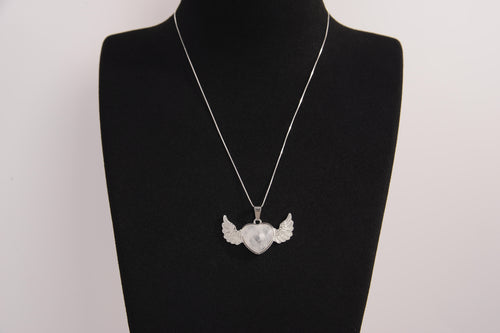 Raw Earth Crystals clear quartz heart with wings necklace, featuring a luminous heart-shaped stone adorned with angelic wings, designed to amplify energy, enhance clarity, and offer spiritual protection.