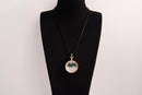 Raw Earth Crystals clear quartz pendant with a crystal-encased design, featuring natural clear quartz and gold-tone setting, enhancing clarity, healing, and spiritual connection.