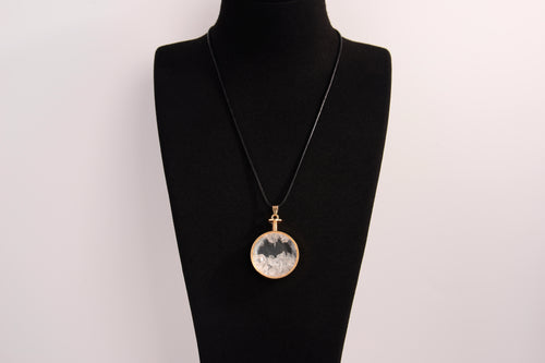 Raw Earth Crystals clear quartz pendant with a crystal-encased design, featuring natural clear quartz and gold-tone setting, enhancing clarity, healing, and spiritual connection.