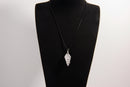 Raw Earth Crystals clear quartz pendant with a spiral wire wrap design, crafted from natural stone to enhance clarity, focus, and spiritual energy.