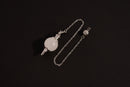 Raw Earth Crystals clear quartz pendulum with silver chain, crafted from natural crystal, promotes clarity, healing, and spiritual insight.