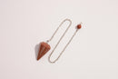 Raw Earth Crystals golden quartz pendulum with pointed crystal and silver chain, designed for manifestation, abundance, and energetic clarity.