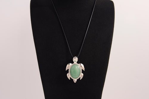 Raw Earth Crystals green aventurine turtle necklace made from natural crystal to attract prosperity, calm the heart, and support emotional balance.