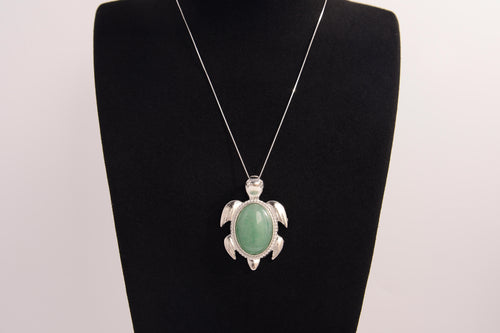 Raw Earth Crystals green aventurine turtle necklace made from natural crystal to attract prosperity, calm the heart, and support emotional balance.
