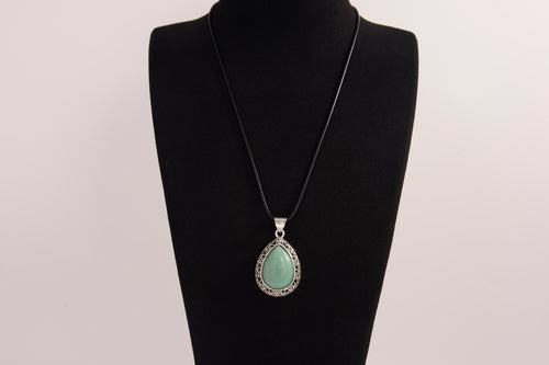 Raw Earth Crystals green aventurine pendant with a teardrop-shaped design, featuring natural green aventurine and an ornate silver-tone setting, promoting prosperity, luck, and emotional balance.