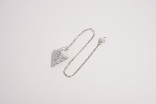 Raw Earth Crystals howlite pendulum with pointed crystal and silver chain, designed for emotional balance, patience, and mental clarity.