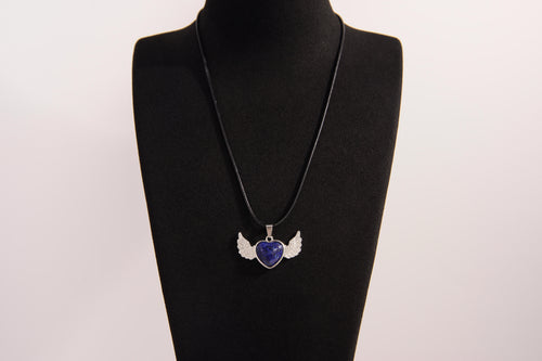 Raw Earth Crystals lapis lazuli heart with wings necklace, featuring a deep blue heart-shaped stone adorned with delicate angelic wings, designed to enhance wisdom, promote self-expression, and support spiritual insight.