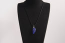 Raw Earth Crystals lapis lazuli pendant featuring an etched design, crafted from natural stone to promote truth, inner wisdom, and spiritual connection.