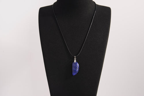 Raw Earth Crystals lapis lazuli pendant featuring an etched design, crafted from natural stone to promote truth, inner wisdom, and spiritual connection.