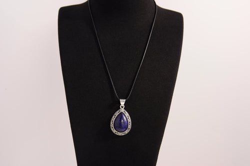Raw Earth Crystals lapis lazuli pendant with a teardrop-shaped design, featuring natural lapis lazuli and an ornate silver-tone setting, promoting wisdom, truth, and spiritual insight.