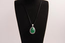 Raw Earth Crystals malachite pendant with a teardrop-shaped design, featuring natural malachite and an ornate silver-tone setting, promoting transformation, abundance, and emotional healing.