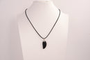 Raw Earth Crystals obsidian angel wing pendant, featuring a polished black obsidian stone carved into an elegant wing shape and set on a silver-tone chain, promoting protection, grounding, and spiritual connection.