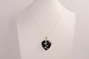 Raw Earth Crystals obsidian heart pendant with an elegant rose design, featuring a sleek black obsidian stone and a silver-tone vine with leaves, promoting protection, grounding, and emotional strength.