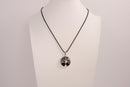 Raw Earth Crystals obsidian pendant featuring a tree of life design, crafted with natural black obsidian and sterling silver, promoting grounding, protection, and spiritual clarity.