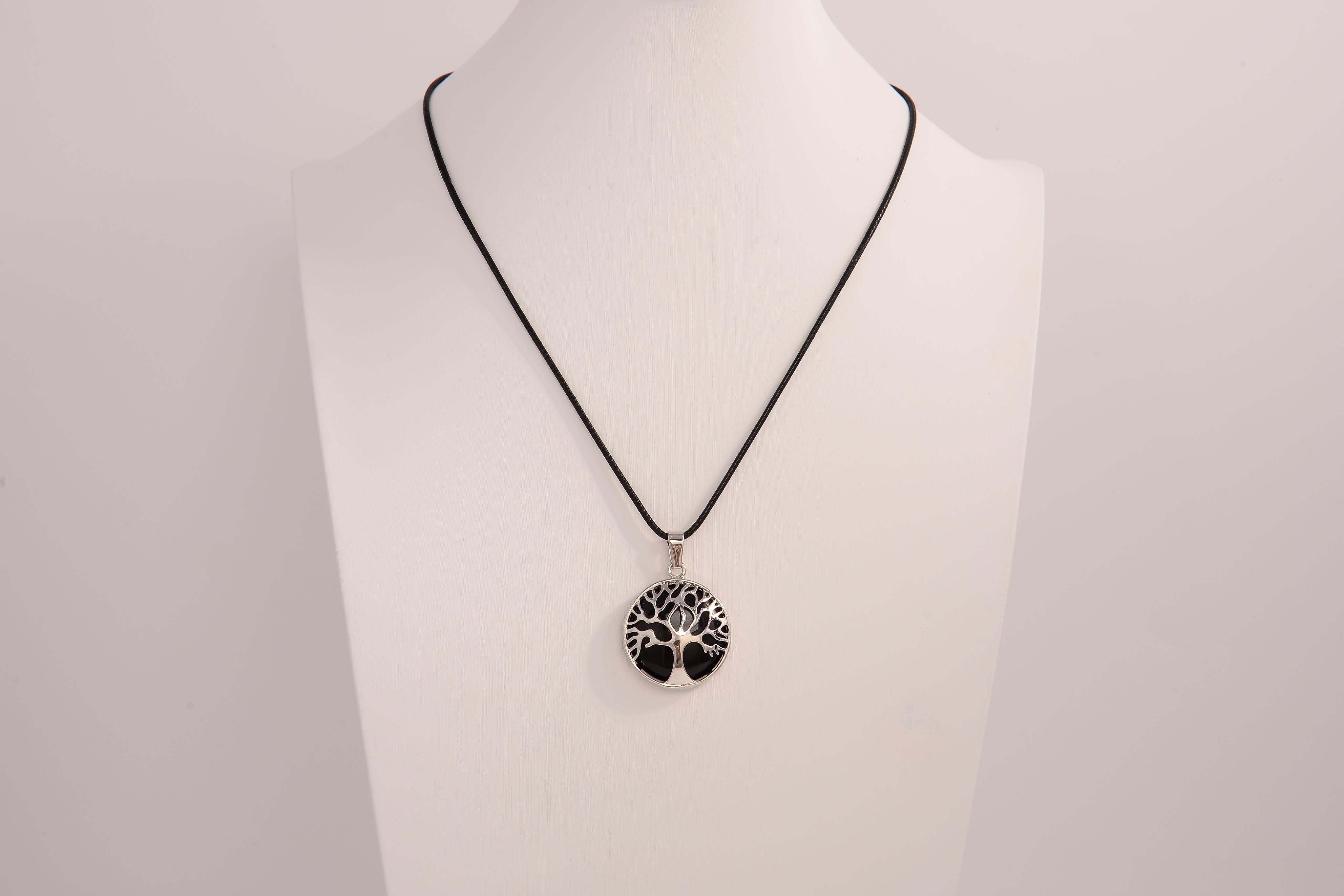 Raw Earth Crystals obsidian pendant featuring a tree of life design, crafted with natural black obsidian and sterling silver, promoting grounding, protection, and spiritual clarity.
