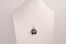 Raw Earth Crystals obsidian pendant featuring a tree of life design, crafted with natural black obsidian and sterling silver, promoting grounding, protection, and spiritual clarity.