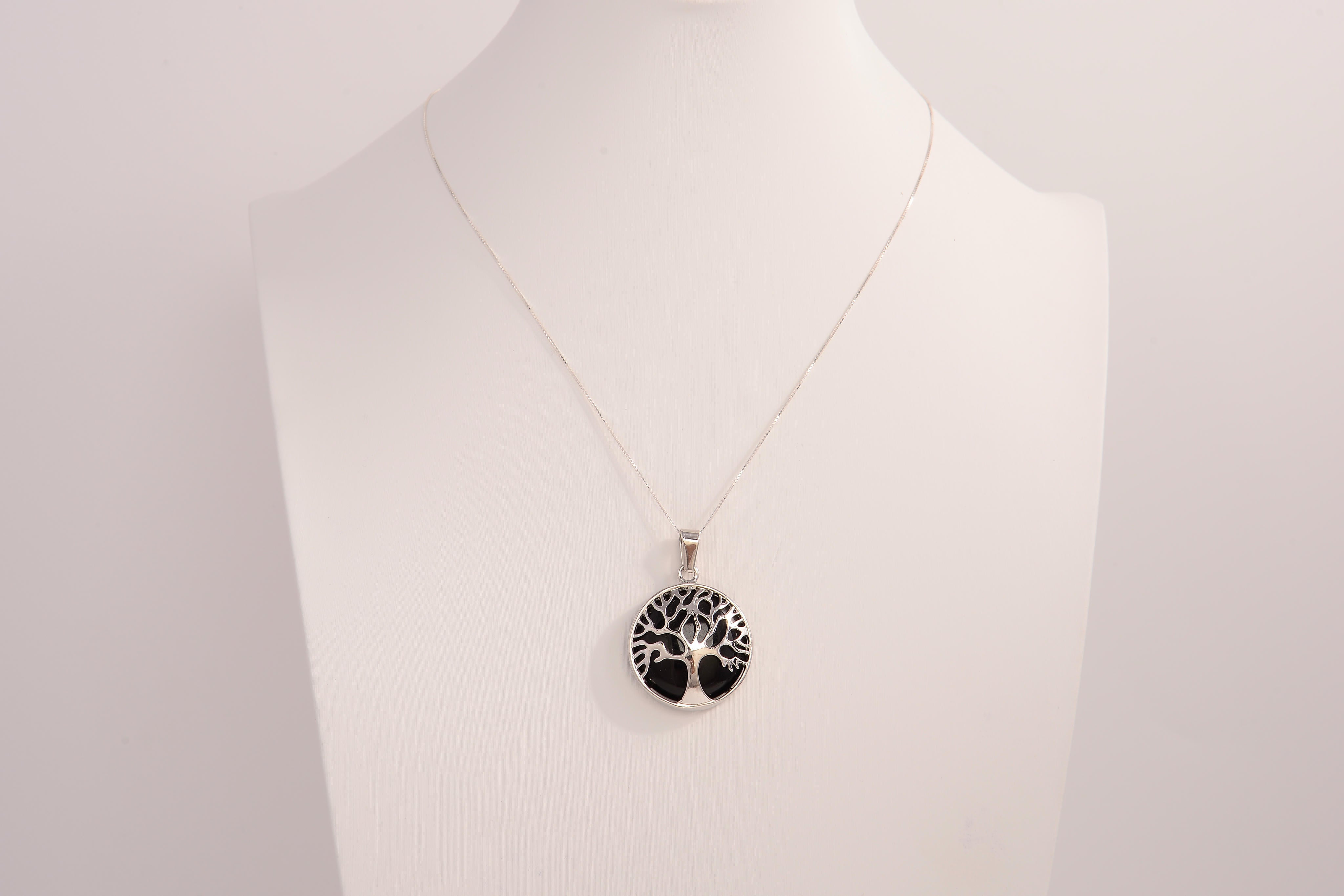 Raw Earth Crystals obsidian pendant featuring a tree of life design, crafted with natural black obsidian and sterling silver, promoting grounding, protection, and spiritual clarity.