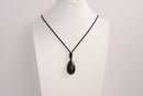 Raw Earth Crystals obsidian teardrop pendant on black cord, crafted from natural obsidian stone, promoting protection, grounding, and emotional clarity.