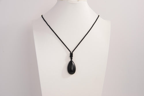 Raw Earth Crystals obsidian teardrop pendant on black cord, crafted from natural obsidian stone, promoting protection, grounding, and emotional clarity.