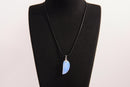 Raw Earth Crystals opalite angel wing pendant, featuring a delicate blue opalite stone carved into an elegant wing shape and set on a silver-tone chain, promoting calmness, spiritual connection, and emotional healing.