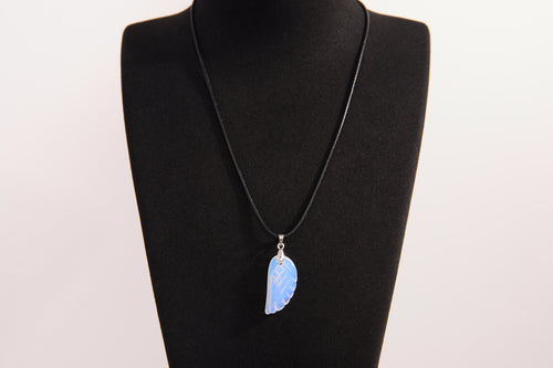 Raw Earth Crystals opalite angel wing pendant, featuring a delicate blue opalite stone carved into an elegant wing shape and set on a silver-tone chain, promoting calmness, spiritual connection, and emotional healing.