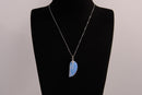 Raw Earth Crystals opalite angel wing pendant, featuring a delicate blue opalite stone carved into an elegant wing shape and set on a silver-tone chain, promoting calmness, spiritual connection, and emotional healing.