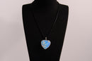 Raw Earth Crystals opalite heart pendant with an elegant rose design, featuring a soft blue opalite stone and a silver-tone vine with leaves, promoting calmness, emotional healing, and spiritual insight.