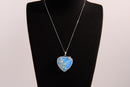 Raw Earth Crystals opalite heart pendant with an elegant rose design, featuring a soft blue opalite stone and a silver-tone vine with leaves, promoting calmness, emotional healing, and spiritual insight.