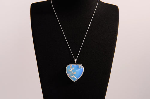 Raw Earth Crystals opalite heart pendant with an elegant rose design, featuring a soft blue opalite stone and a silver-tone vine with leaves, promoting calmness, emotional healing, and spiritual insight.