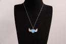 Raw Earth Crystals opalite heart with wings necklace, featuring a luminous blue heart-shaped stone adorned with delicate angelic wings, designed to enhance emotional healing, promote inner peace, and inspire spiritual connection.