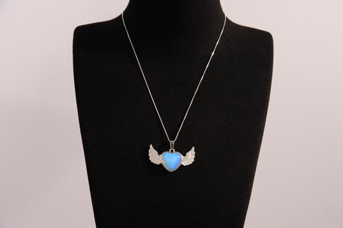 Raw Earth Crystals opalite heart with wings necklace, featuring a luminous blue heart-shaped stone adorned with delicate angelic wings, designed to enhance emotional healing, promote inner peace, and inspire spiritual connection.