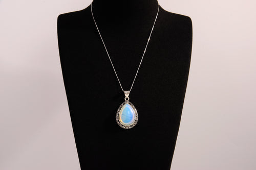 Raw Earth Crystals opalite pendant with a teardrop-shaped design, featuring natural opalite and an ornate silver-tone setting, enhancing emotional balance, intuition, and spiritual connection.