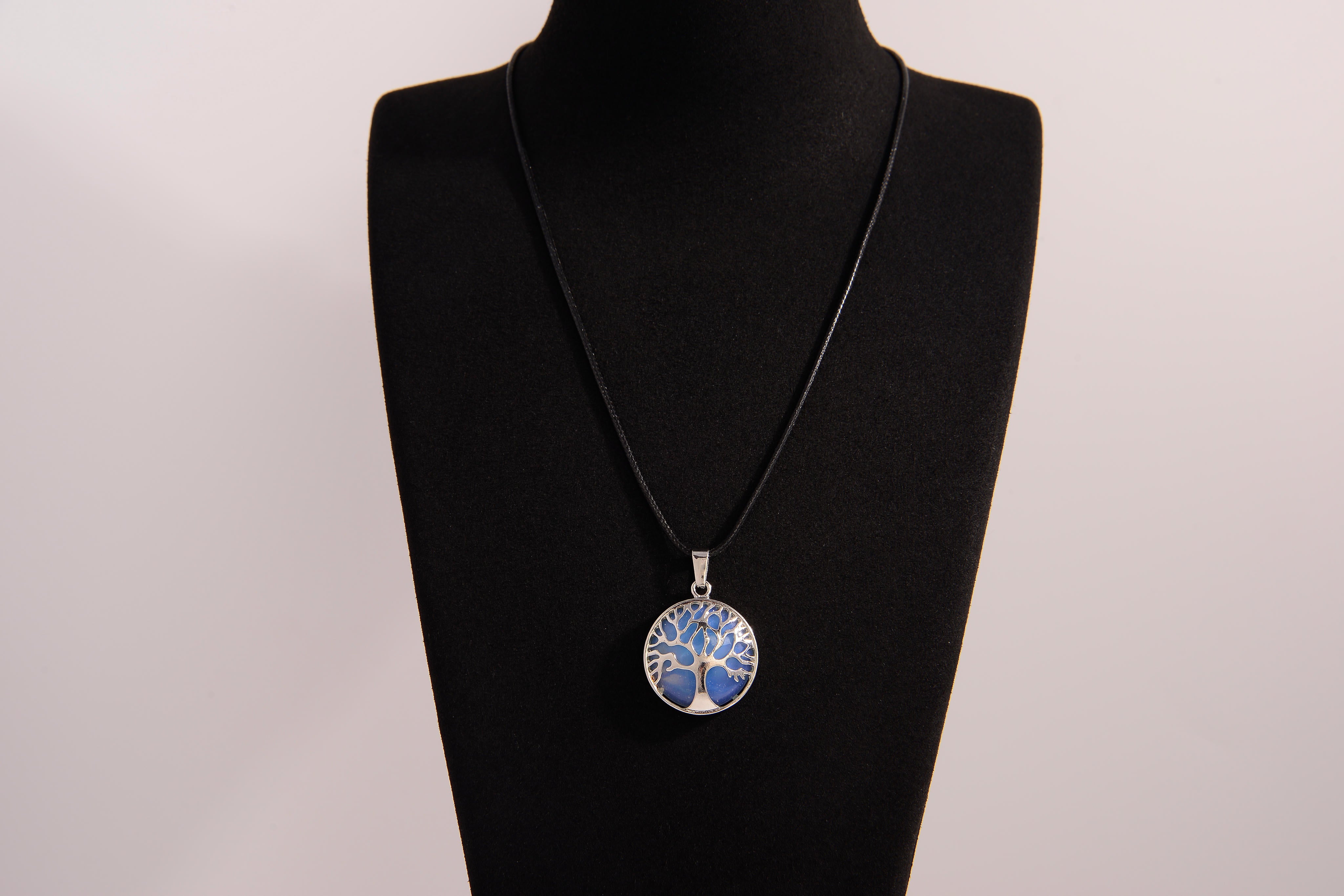 Raw Earth Crystals opalite pendant featuring a tree of life design, crafted with natural crystal for emotional healing, calmness, and spiritual growth.